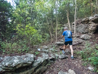 Dennis drinking and negotiating the rocks.
