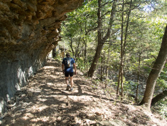 Under overhanging cliffs, heading back. Tired, sweaty and hot.