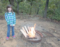 Flannel girl by the fire. We're drying out wood.