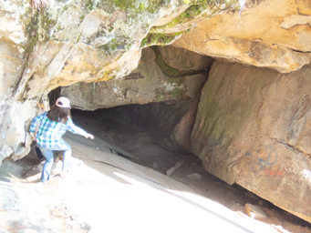Jeralyn goes down into the cave.