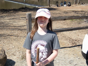 Preparing to hike the Mountain Trail. Suncreened, hatted and sticked. She's not happy.
